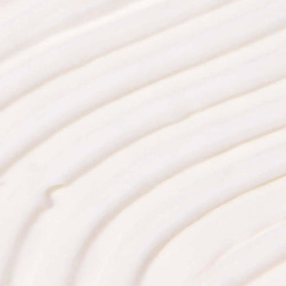 Close-up of creamy, TREE HUT Coco Colada Whipped Body Butter whipped body butter texture with soft, smooth swirls.