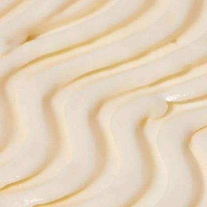 Close-up of creamy, Tree Hut Whipped Body Butter Tropic Glow whipped body butter with smooth, textured swirls, perfect for hydration and nourishment.
