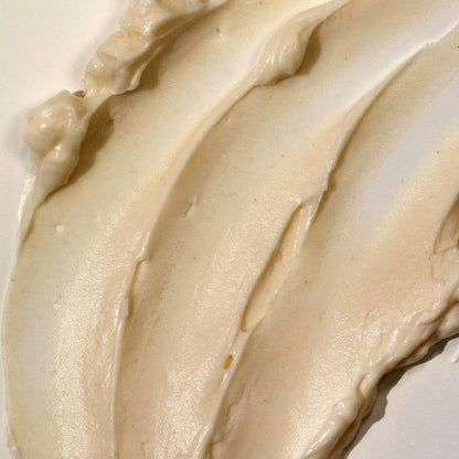 Close-up of smooth, beige cream of Tree Hut Whipped Body Butter Tropic Glow  on a white background