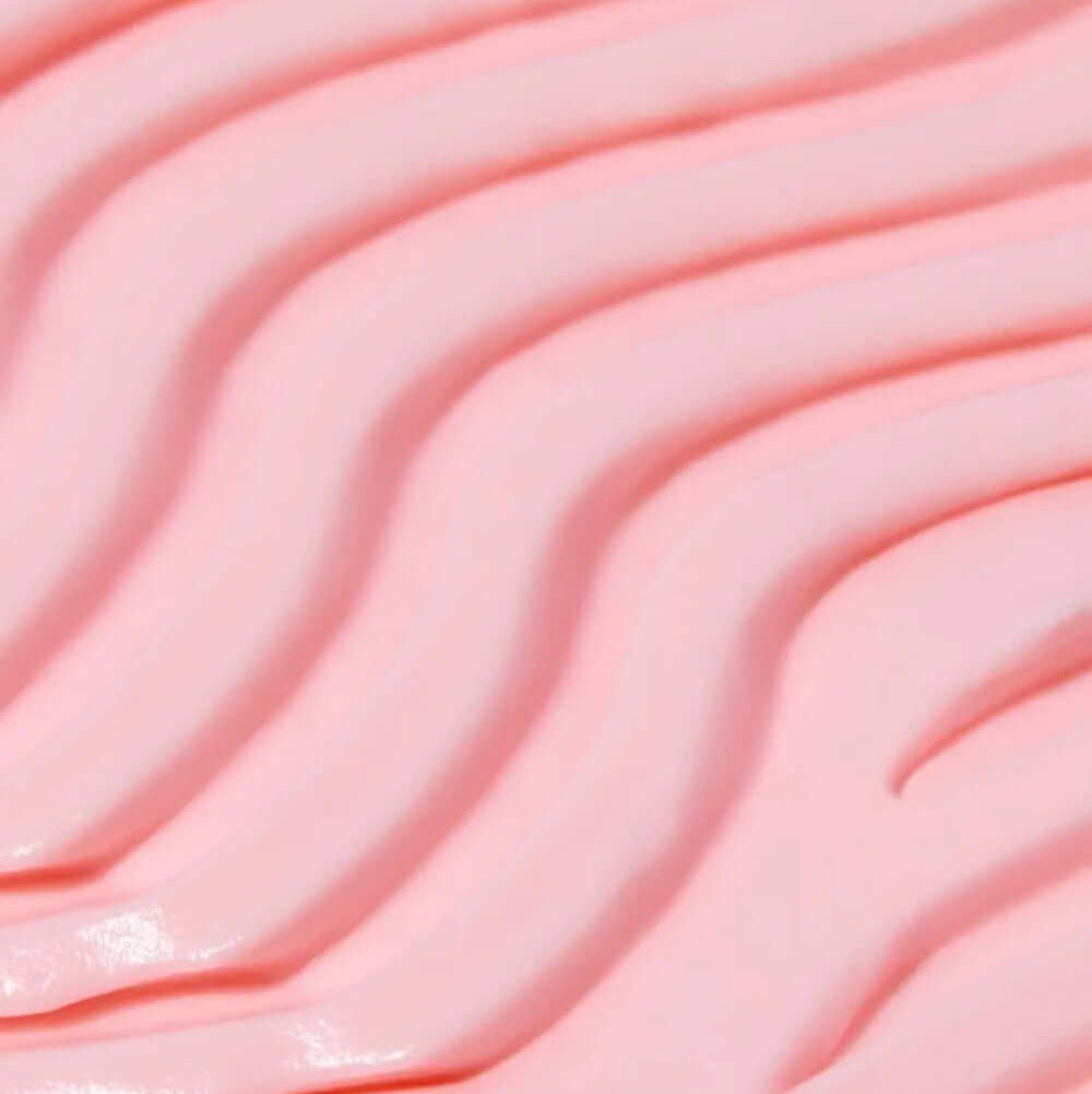 Close-up of smooth, pink TREE HUT Whipped Body Butter with wavy texture, showcasing its creamy consistency.
