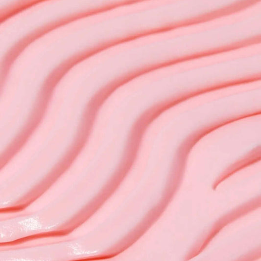 Close-up of smooth, pink TREE HUT Whipped Body Butter with wavy texture, showcasing its creamy consistency.