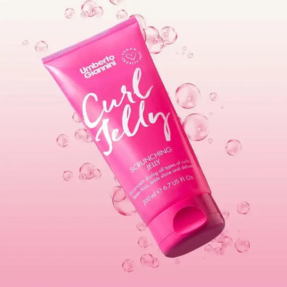 Pink bottle of Umberto Giannini Curl Jelly on a pink background with bubbles