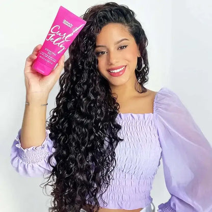 Woman with long, wavy hair holding a pink bottle of 'Girl Fuel' product against a white background
