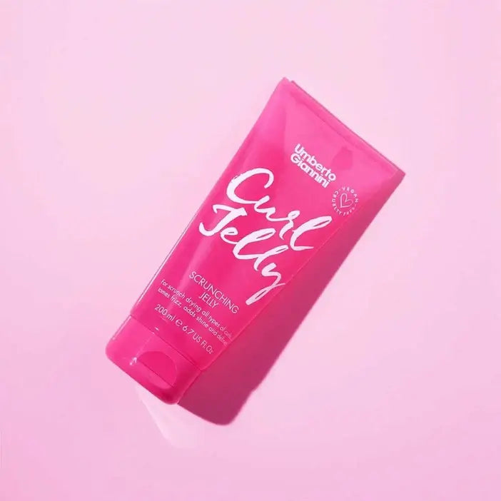 Pink bottle of Umberto Giannini Curl Jelly on a pink background