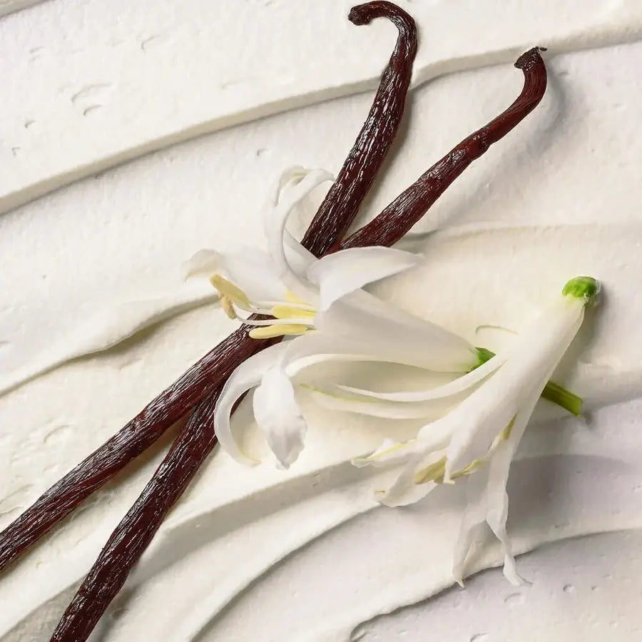 eos Vanilla beans and vanilla flower on a light wooden surface