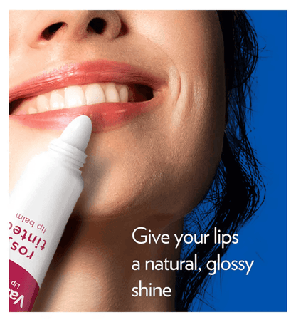 Woman applying Vaseline Rosy Tinted Lip Balm for a natural, glossy shine on her lips.
