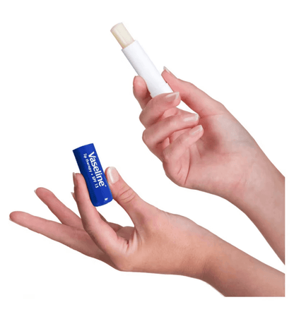 Vaseline Lip Therapy Stick Original held in hand, showcasing its moisturizing benefits for dry lips.