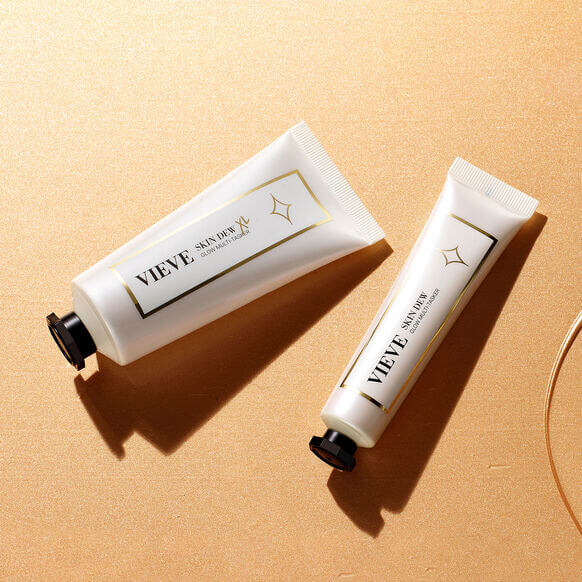 VIEVE Skin Dew and Skin Prep tubes on a gold background, showcasing their elegant design and radiant skincare benefits.