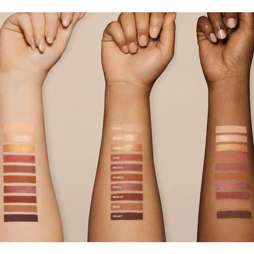 Three arms with swatches of Vieve makeup on a beige background