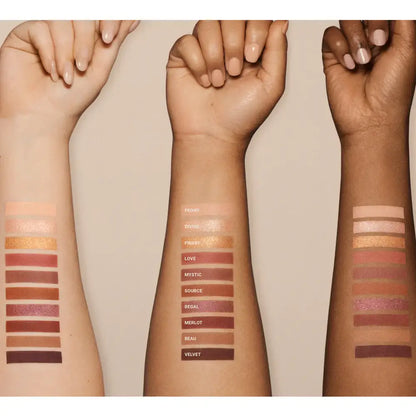 Three arms with swatches of Vieve makeup on a beige background