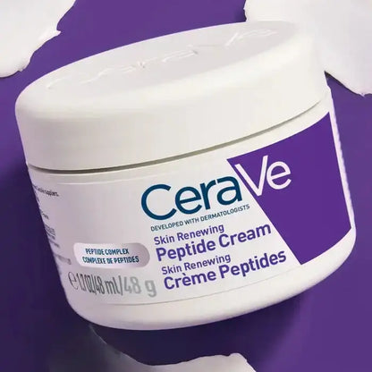 CeraVe Skin Renewing Peptide Cream 50ml jar surrounded by cream swatches on purple background
