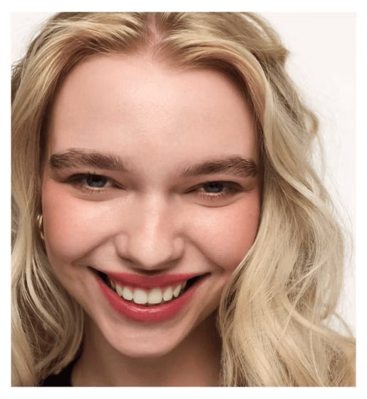 Smiling woman showcasing vibrant lips with Wonderskin Wonder Blading Lip Stain Masque for a fresh, beautiful look.