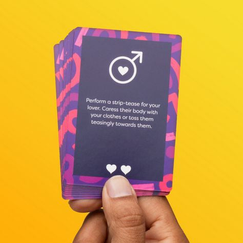 Hand holding a card with a symbol and text on a yellow background