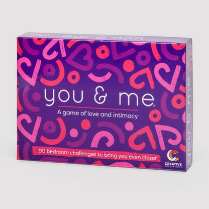 Board game box titled 'you & me' with colorful heart patterns on a purple background.