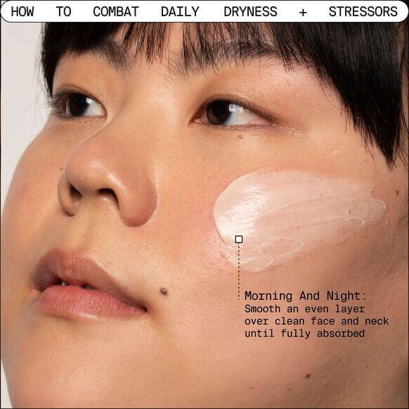 Close-up of a person applying Youth To The People Adaptogen Deep Moisture Cream to their face for hydration.