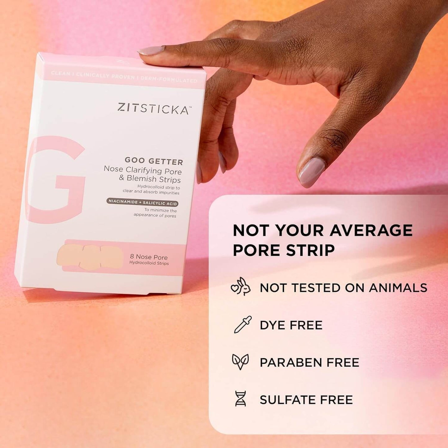 Zitsticka Goo Getter pore strip packaging with a hand holding it against a pink gradient background.