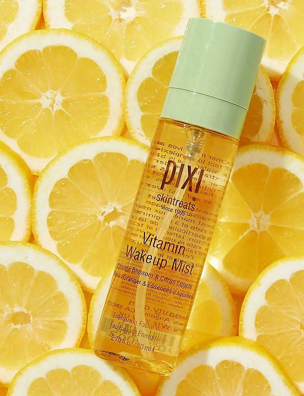 PIXI Vitamin Wakeup Mist 80ml on sliced lemons, a refreshing toner mist for revitalized skin and energized complexion.