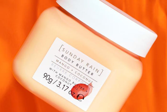 Sunday Rain Mango & Coconut Body Butter, 90ml in a jar, rich moisturizer for dry skin with nourishing ingredients.
