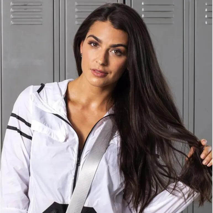 Woman with long hair wearing a sporty jacket, showcasing healthy hair post workout. Ideal for using Bumble & Bumble dry shampoo.