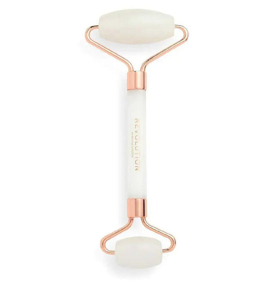 Revolution Skincare White Jade Roller with rose gold accents for depuffing and revitalizing skin.