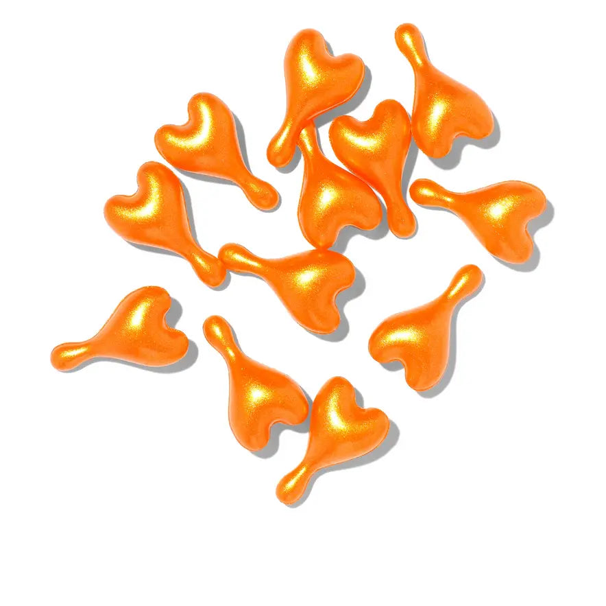 Oskia Super-C Capsules in vibrant orange, ideal for boosting skin health and achieving a youthful glow.