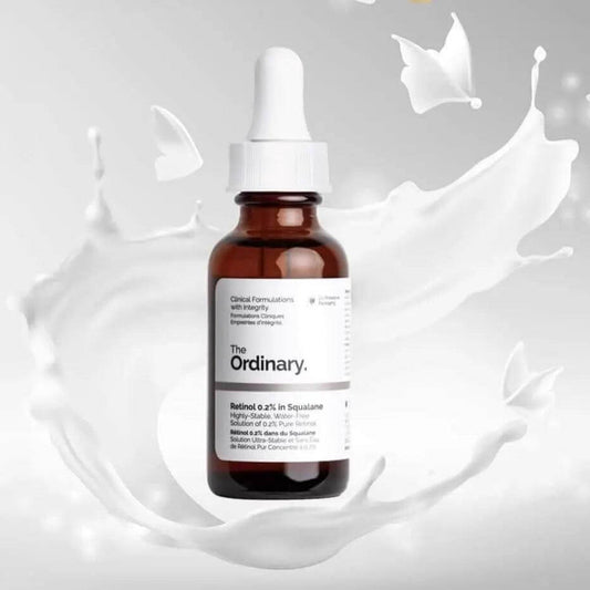 The Ordinary Retinol 0.2% in Squalane 30ml bottle surrounded by flowing cream background.