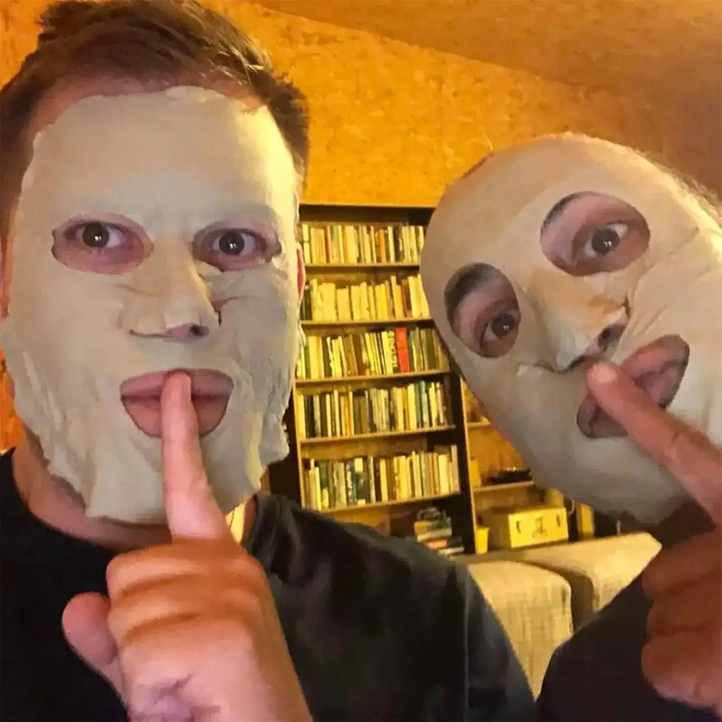 Two friends with facial masks enjoying a fun skincare moment, promoting self-care and relaxation.