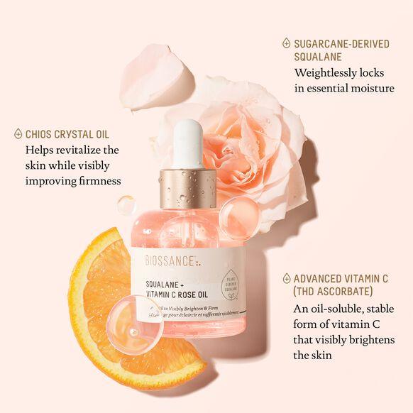 Biossance Squalane + Vitamin C Rose Oil with rose and orange slice, highlighting skin hydration and firmness.