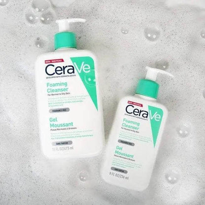 CeraVe Foaming Cleanser 473ml and 236ml bottles on a soapy surface, designed for oily to normal skin types.