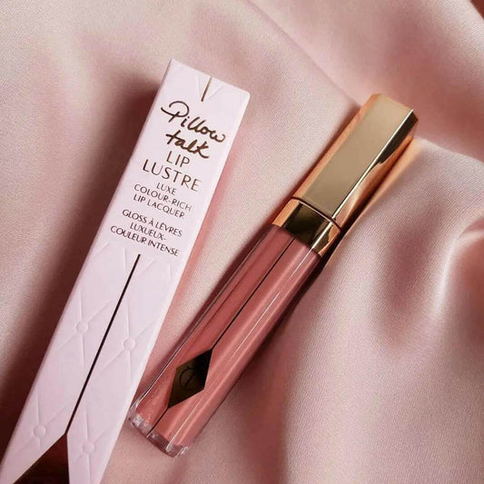 Charlotte Tilbury Pillow Talk Lip Lustre lip gloss in 3.5ml, featuring nude-pink shade and glossy finish on a soft fabric background.