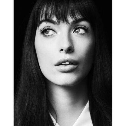 Black and white portrait of a model showcasing Laura Mercier long, defined lashes and a natural makeup look.
