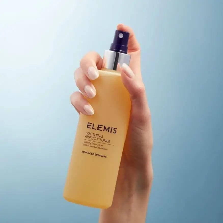 ELEMIS Soothing Apricot Toner 200ml spray bottle held in hand with a soothing blue background.