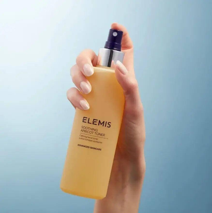 ELEMIS Soothing Apricot Toner 200ml spray bottle held in hand with a soothing blue background.