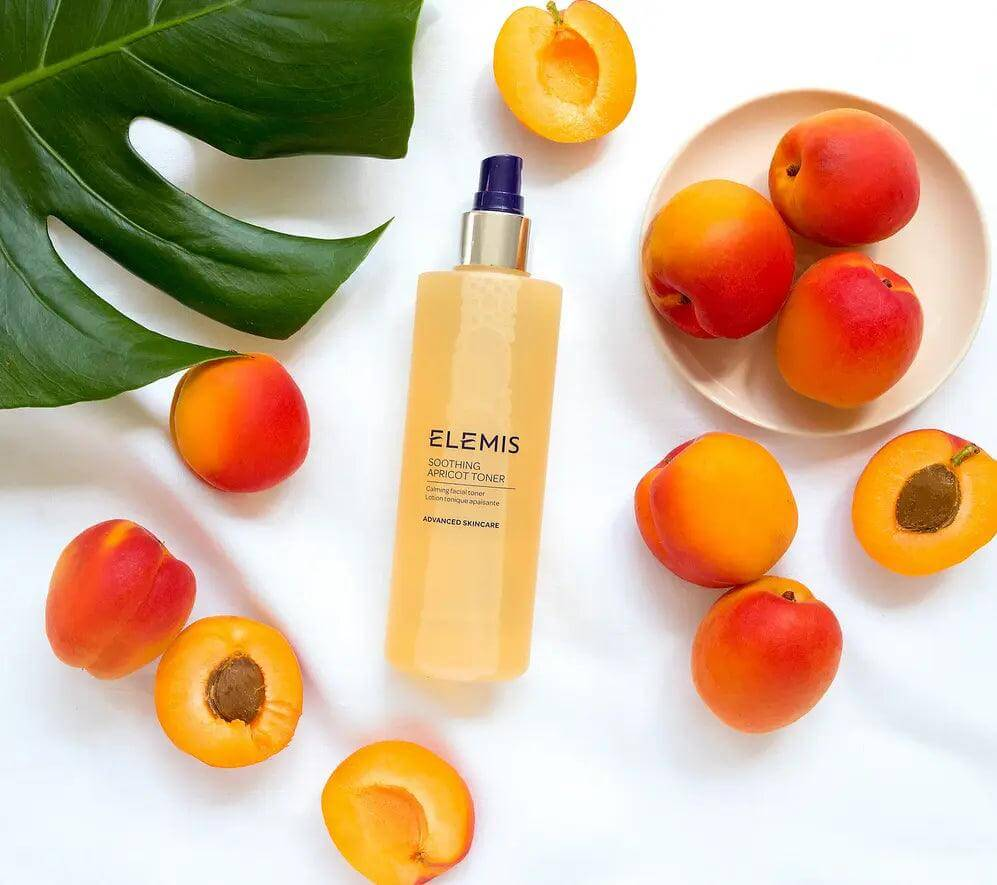 ELEMIS Soothing Apricot Toner 200ml surrounded by fresh apricots on a light backdrop, ideal for sensitive skin.