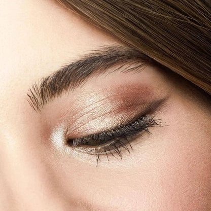 Close-up of a woman's eye showcasing a beautiful e.l.f. eyeshadow look with creamy, shimmery tones.