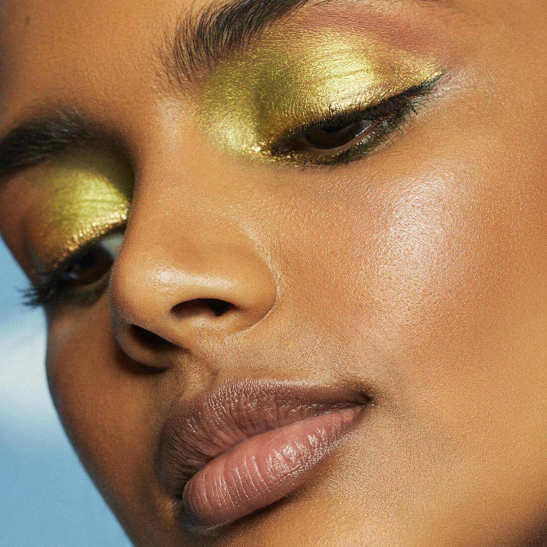 Close-up of model wearing vibrant green eyeshadow, showcasing the bold look with e.l.f. Bite Size Eyeshadows - Hot Jalapeño.
