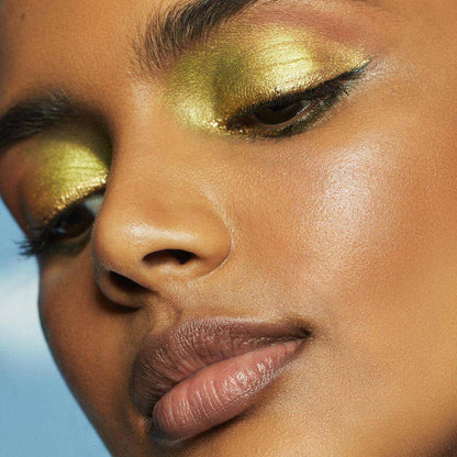 Close-up of model wearing vibrant green eyeshadow, showcasing the bold look with e.l.f. Bite Size Eyeshadows - Hot Jalapeño.
