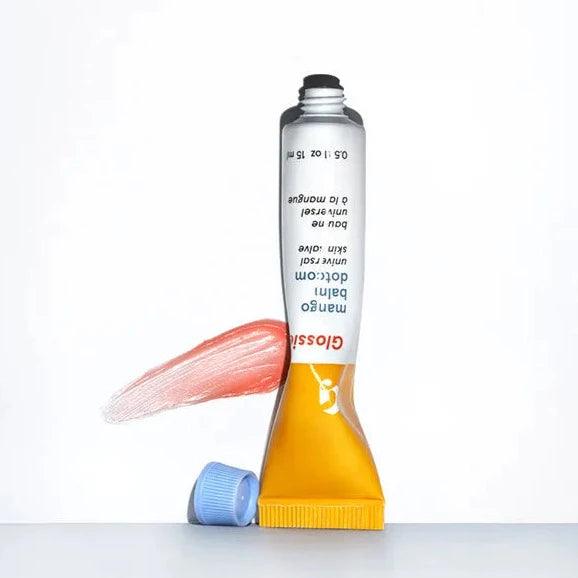 Glossier Balm Dotcom in Mango, a hydrating lip balm tube with sheer tint and antioxidants for moisturized lips.