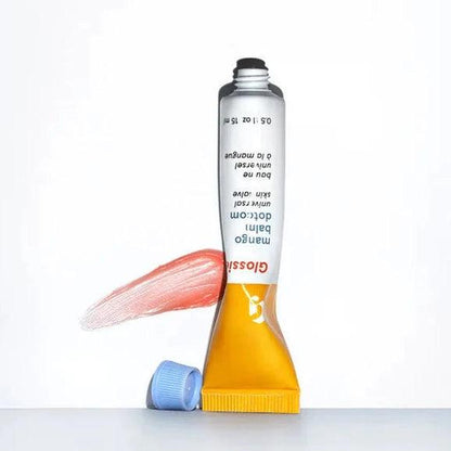 Glossier Balm Dotcom in Mango, a hydrating lip balm tube with sheer tint and antioxidants for moisturized lips.