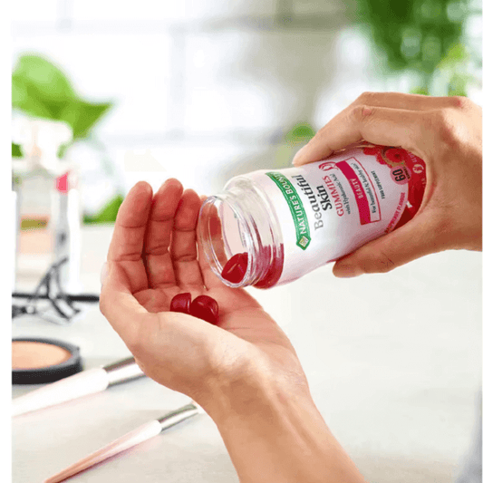 Nature's Bounty Beautiful Skin vegan gummies being poured into a hand, promoting healthy skin and beauty from within.