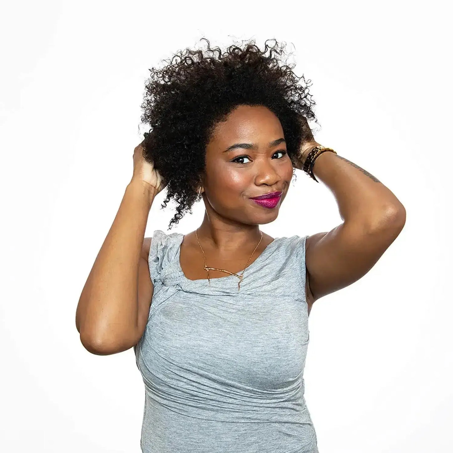 Woman with curly hair showcasing  K18healthy locks, celebrating hair care and vitality.