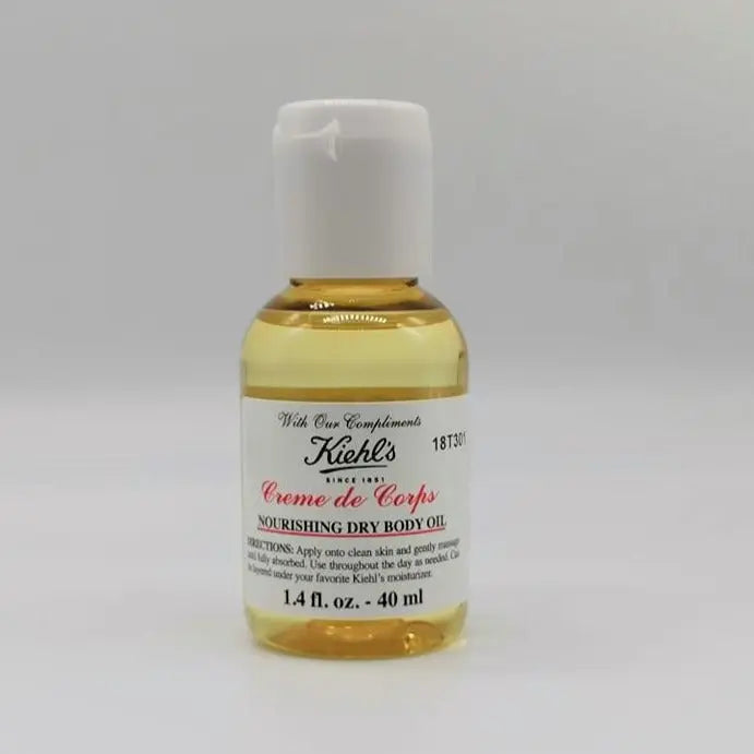 Kiehl's Creme de Corps Nourishing Dry Body Oil 40ml in a clear bottle, designed for all skin types with a lightweight formula.