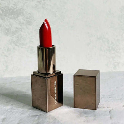 Laura Mercier Rouge Essentiel Silky Crème Mini Lipstick in Rouge Ultime, medium-dark red lipstick in sleek metallic case.