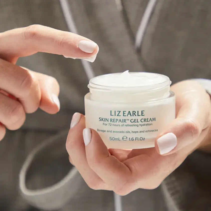 Liz Earle Skin Repair Gel Cream being held, showcasing its lightweight, hydrating formula for refreshed skin.