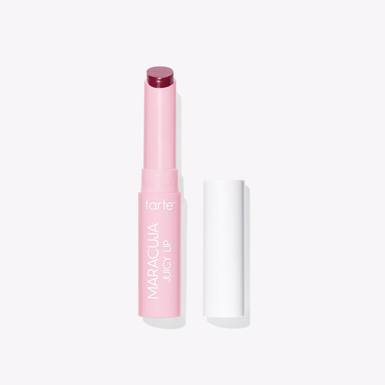 TARTE travel-size maracuja juicy lip balm in pink packaging, showcasing moisturizing and plumping properties for juicy lips.