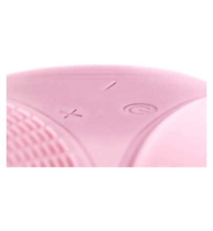 Close-up of the control buttons on the Magnitone XOXO SoftTouch Silicone Cleansing Brush in pink.