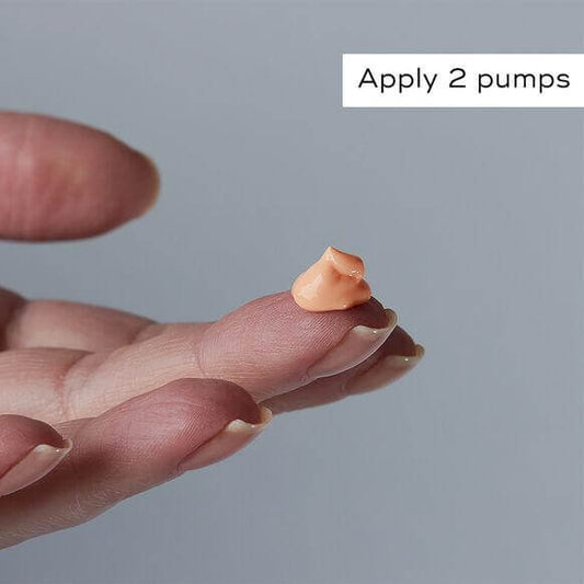 Hand holding a small amount of Medik8 Crystal Retinal 3 serum, demonstrating how to apply 2 pumps.