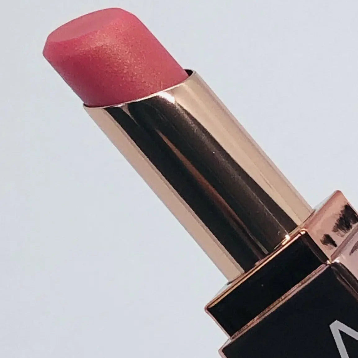 NARS mini Orgasm Afterglow Pink Lip Balm in a tube, showcasing its smooth, radiant pink color.