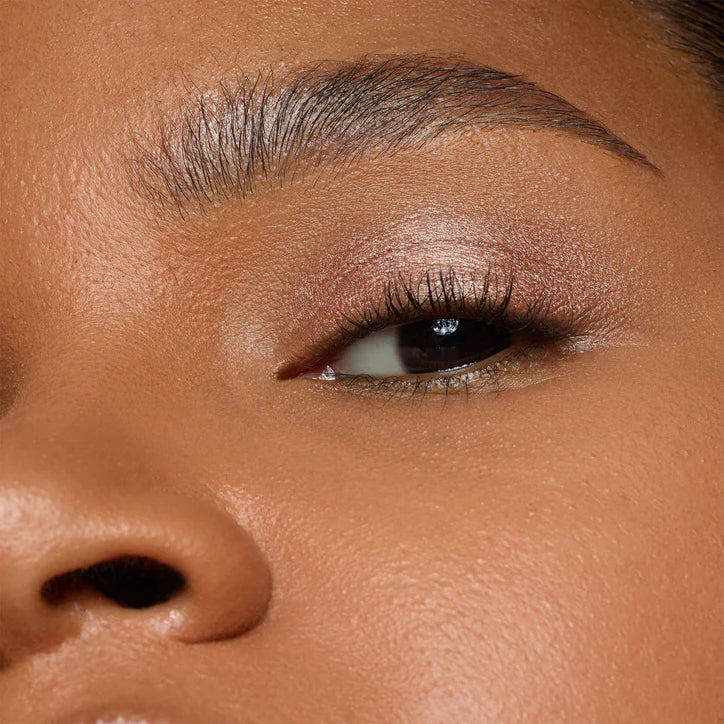 Close-up of model's eye showcasing NUDESTIX shimmery eye makeup color with a radiant glow.