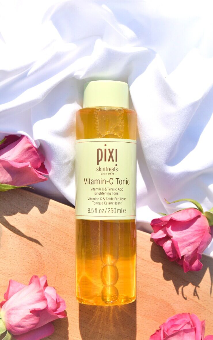 PIXI Vitamin-C Tonic 250ml bottle with roses, features antioxidant-rich formula for brightened skin.